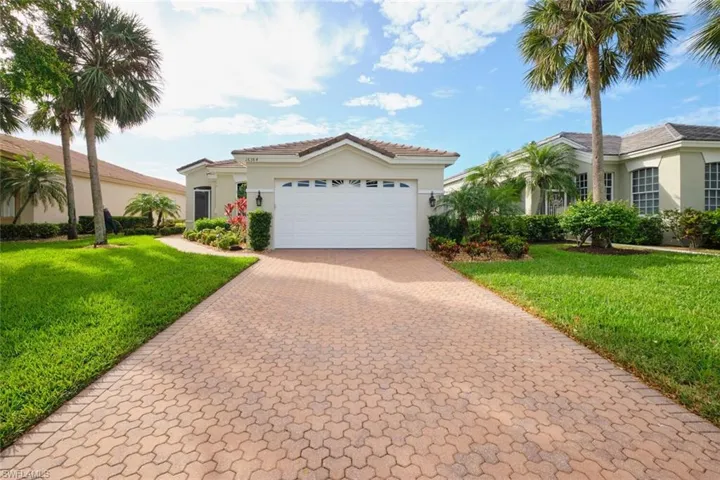 Mediterranean / spanish-style house with a front yard and a garage
