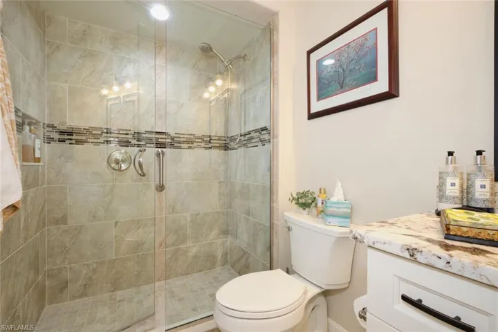 Bathroom with a shower with door and toilet