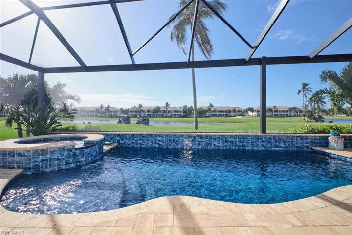 View of swimming pool featuring a water view, an in ground hot tub, and a lanai