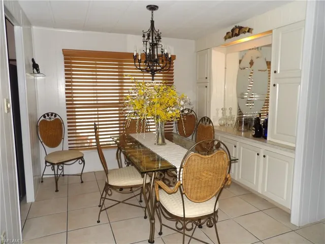 Dining room featuring a chandelier and light tile patterned floors