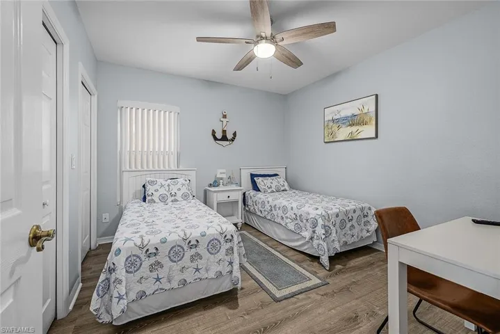 Bedroom featuring a closet, wood finished floors, and ceiling fan