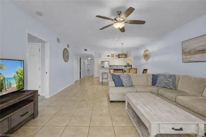 Living room featuring ceiling fan and light tile patterned flooring