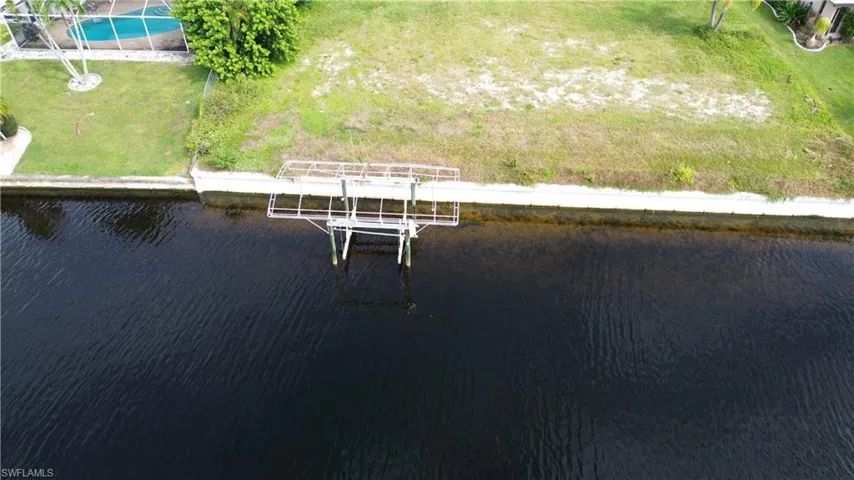 Drone / aerial view of a large body of water and a pool area