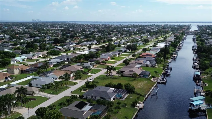 Aerial overview of property's location with a large body of water and nearby suburban area
