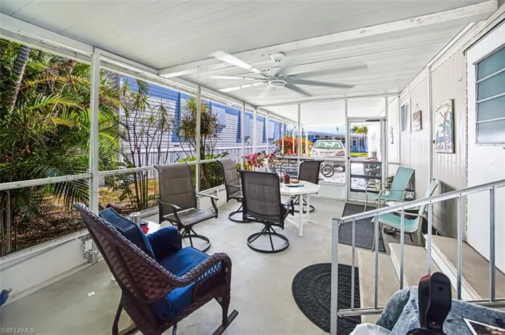 Sunroom / solarium featuring ceiling fan and outdoor dining area