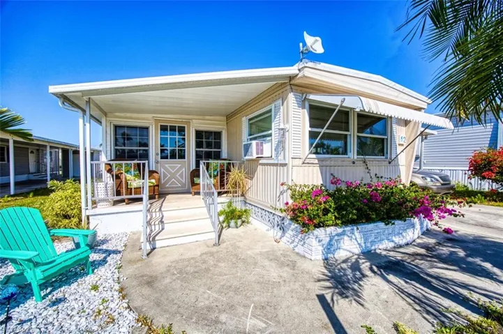 View of front of house featuring a porch and cooling unit