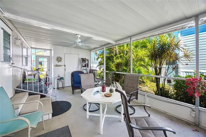 Sunroom / solarium with ceiling fan and healthy amount of natural light
