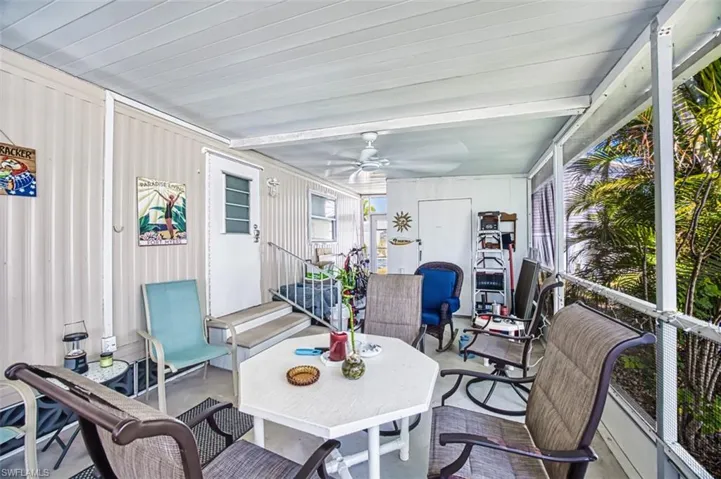 Sunroom featuring a ceiling fan
