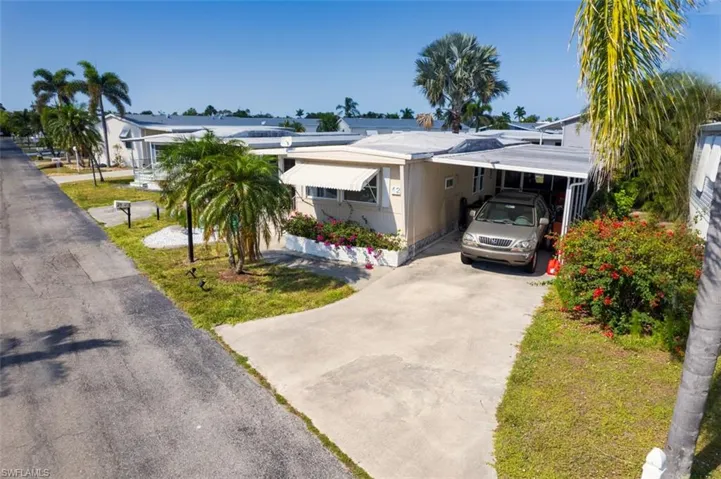 View of front of home featuring concrete driveway and an attached carport