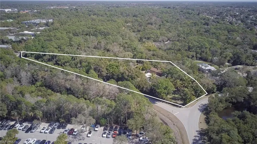 Aerial view of property's location featuring a forest and property boundaries highlighted