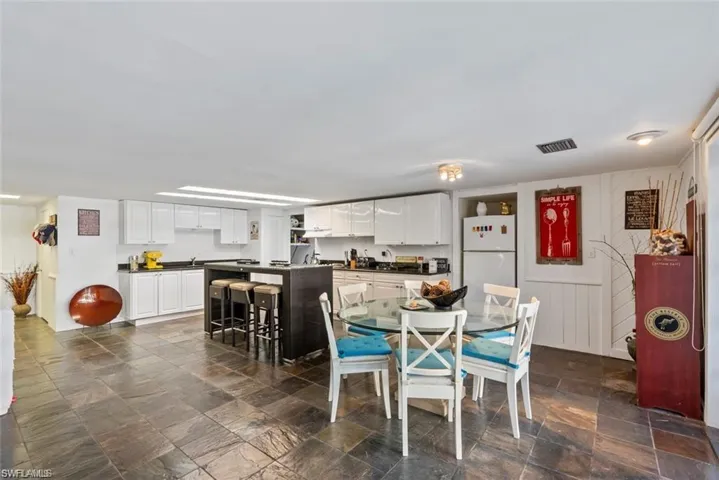 Dining room featuring dark stone finish floors