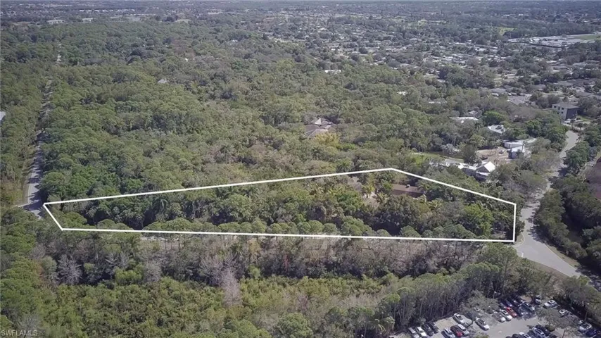View of property location featuring a heavily wooded area and property parcel outlined