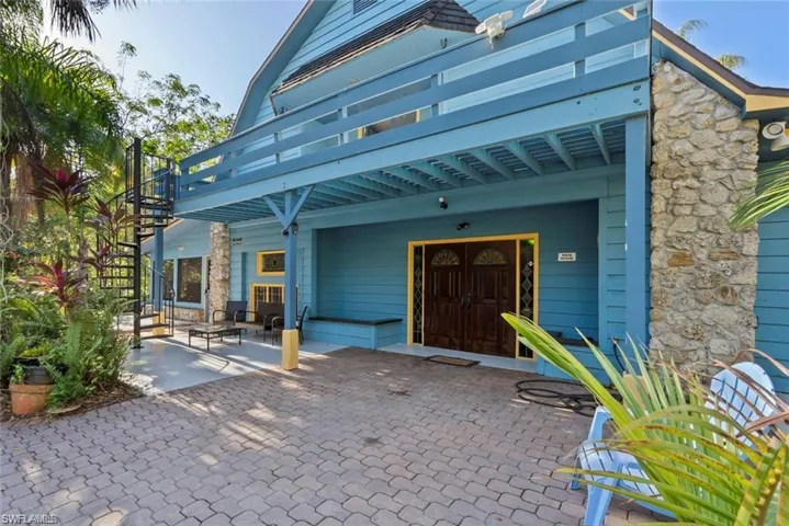 View of exterior entry with a patio and a pergola