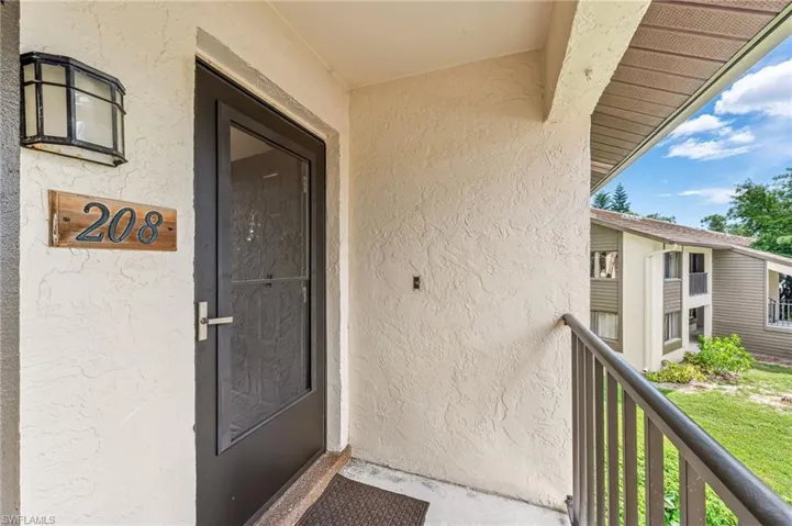 View of exterior entry with stucco siding