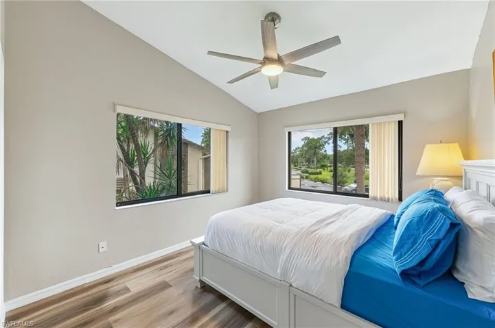 Bedroom featuring wood finished floors, vaulted ceiling, and ceiling fan
