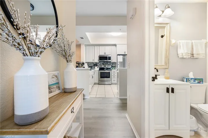 Open concept layout featuring wood-finish flooring extending into the kitchen