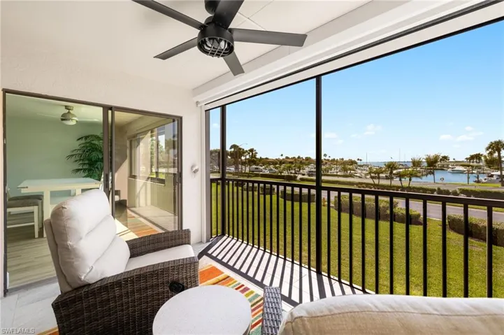 Sunroom featuring a water view and a ceiling fan