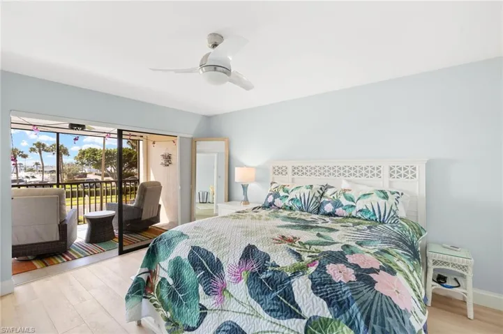 Bedroom with access to outside, light wood-style flooring, and ceiling fan