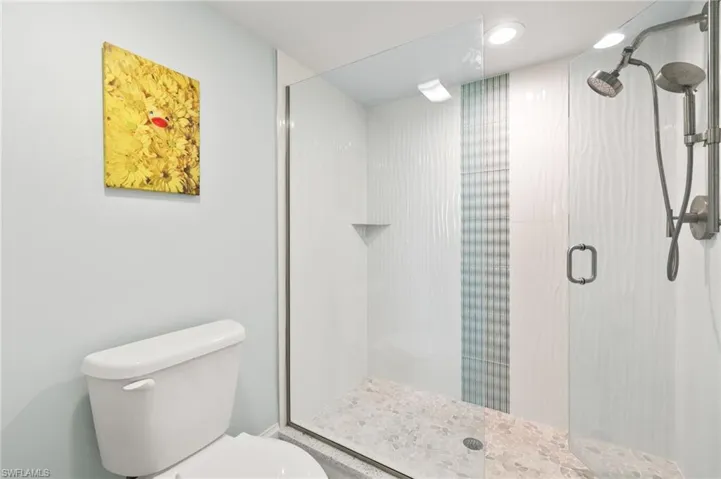 Bathroom with a stall shower and toilet