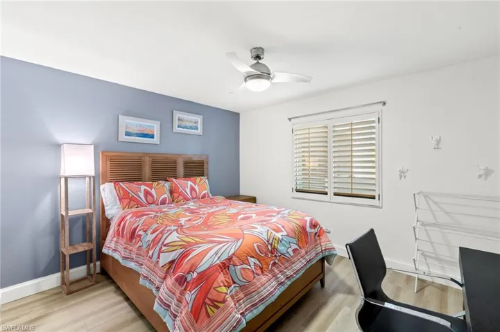 Bedroom with a ceiling fan, baseboards, and light wood finished floors