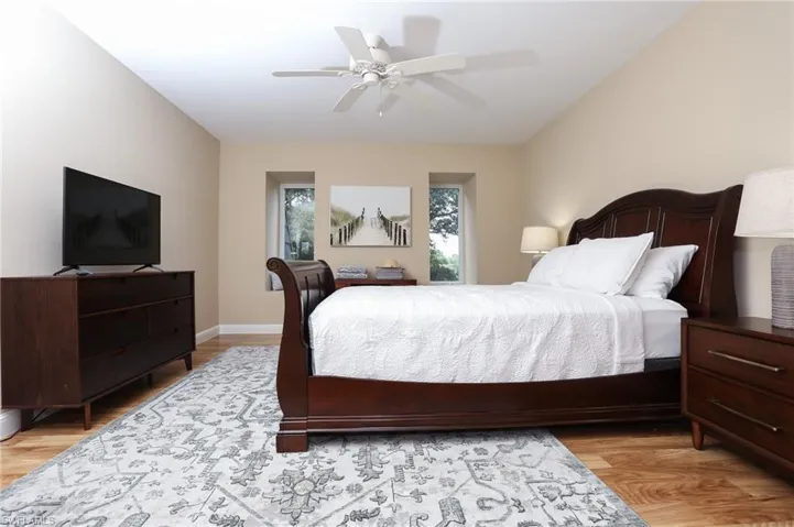 Bedroom with ceiling fan and light wood finished floors