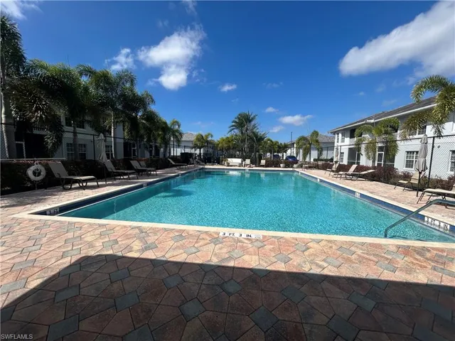 Community pool with a patio