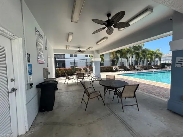 Community pool featuring a patio area and outdoor dining area