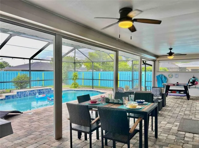 View of swimming pool featuring a fenced backyard, a patio area, and a ceiling fan