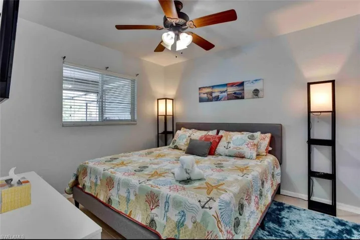 Bedroom with ceiling fan and baseboards