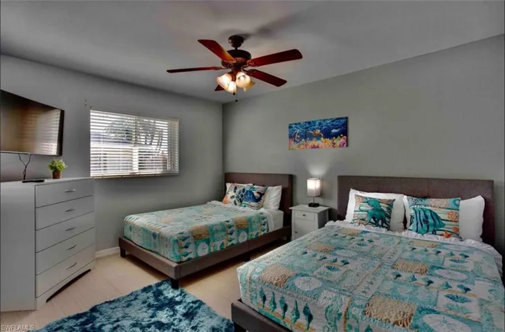 Bedroom featuring baseboards and ceiling fan