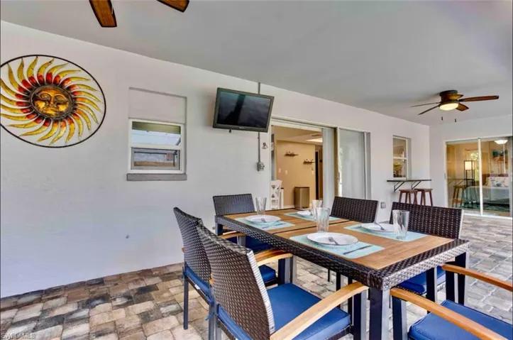Dining room with a ceiling fan and stone finish flooring