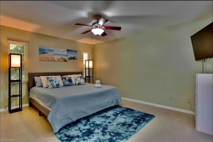 Bedroom featuring baseboards and ceiling fan