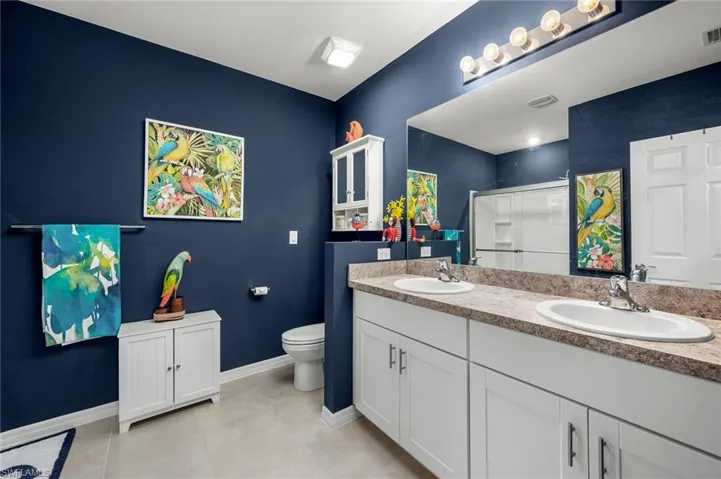 Large Master Bathroom with double vanity, walk-in shower, and linen closet