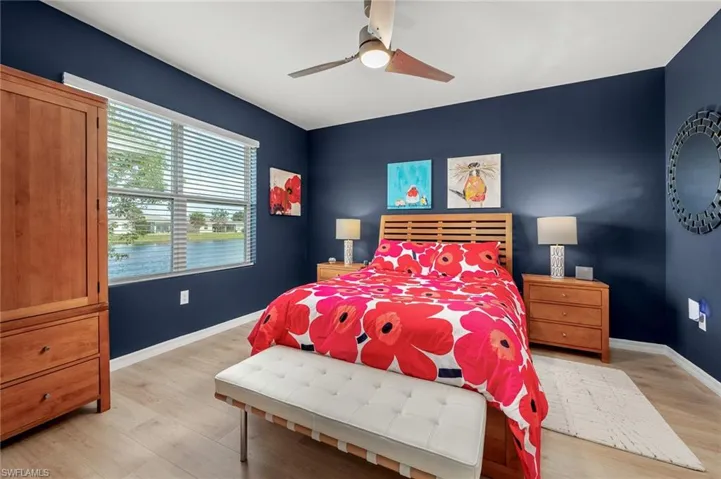 Master Bedroom featuring large picture window with view of lake, LVP flooring