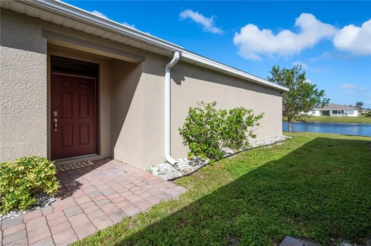 Entrance to property with view of the lake in the backyard