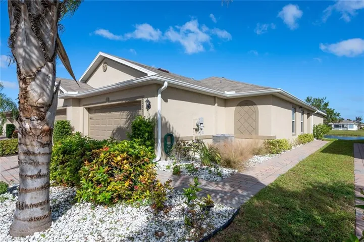 View of home's exterior featuring a lawn and a garage
