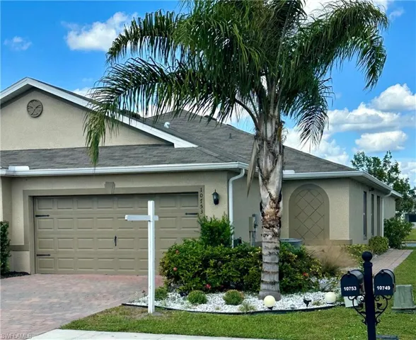 View of front facade with a garage and a front lawn