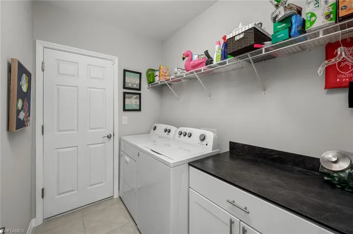 Indoor laundry room leading to two car arage. Washer & Dryer included