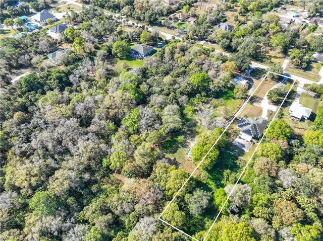 Aerial view of property and surrounding area featuring property boundaries highlighted