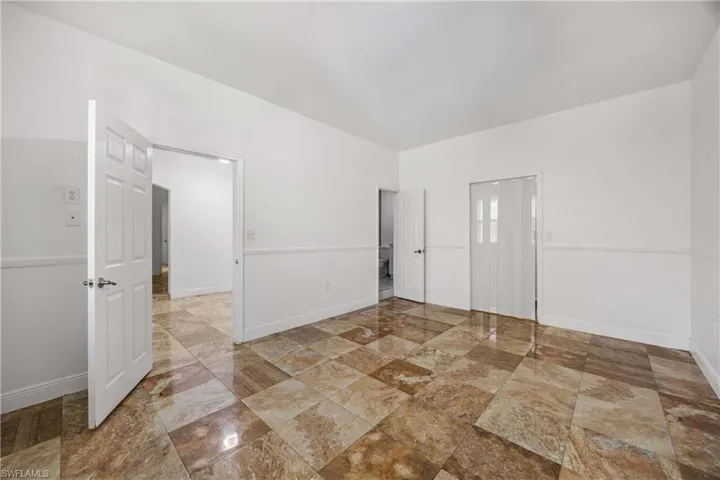 Unfurnished room featuring baseboards