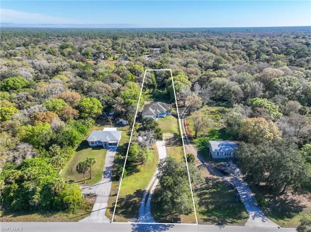 View of property location with property boundaries highlighted and a heavily wooded area