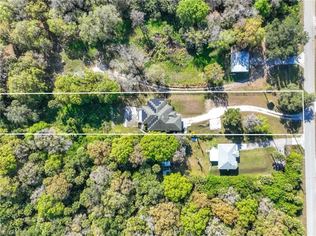 Aerial view of property and surrounding area featuring property parcel outlined