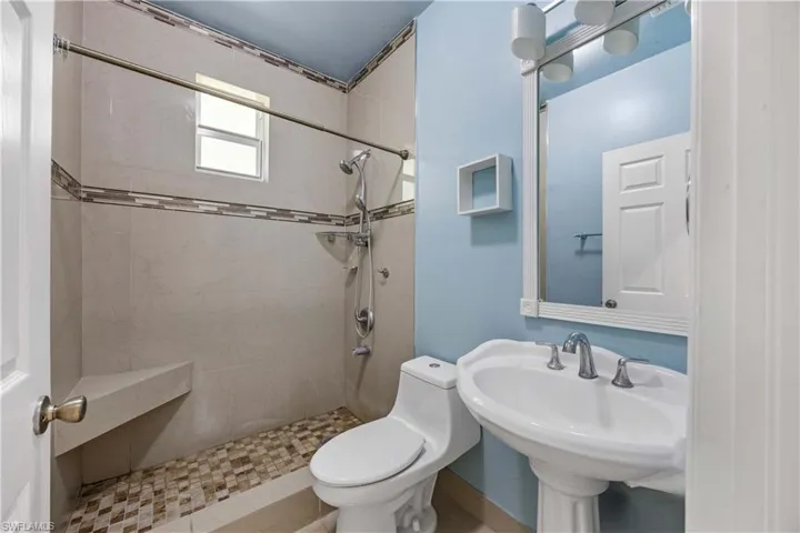 Full bathroom with toilet and a shower stall