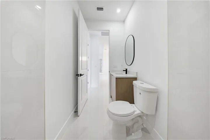 Full bath featuring vanity and toilet