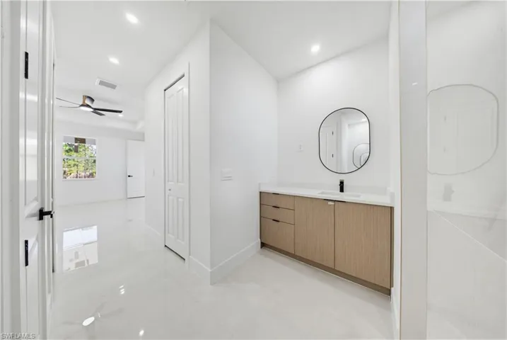 Bathroom with vanity, recessed lighting, and ceiling fan