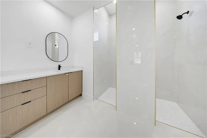 Full bath featuring a walk in shower and vanity