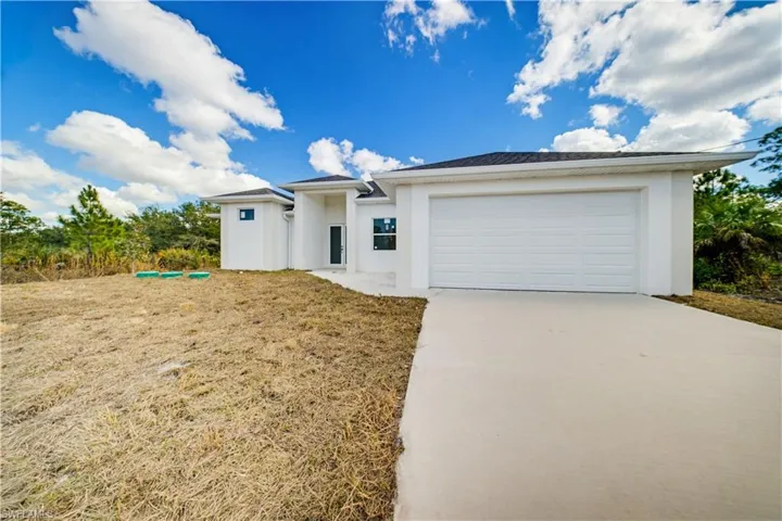 Prairie-style home featuring stucco siding, concrete driveway, and an attached garage