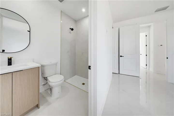 Full bath with a shower stall and vanity