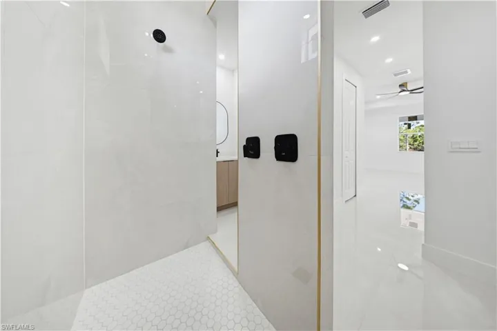 Bathroom featuring a walk in shower, vanity, a ceiling fan, and recessed lighting