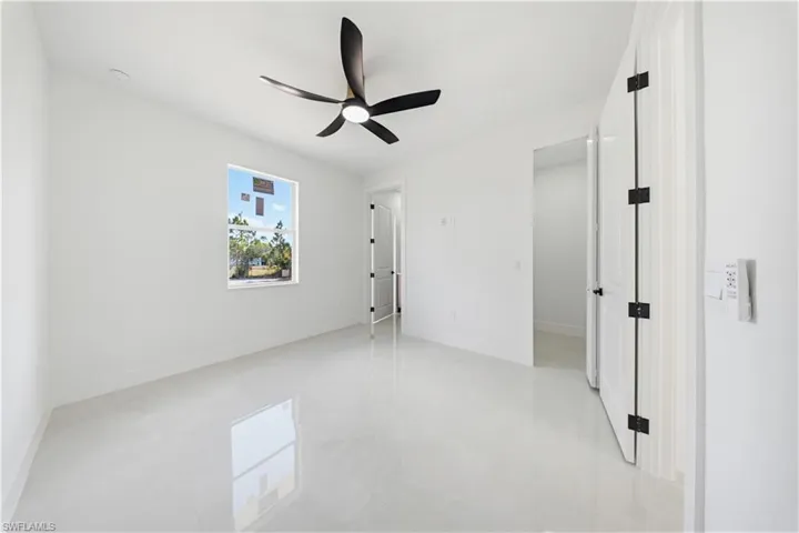 Unfurnished bedroom with ceiling fan and baseboards
